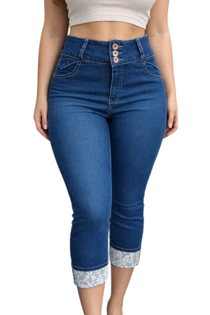 Blue jeans with floral cuffs worn by a person on a white background