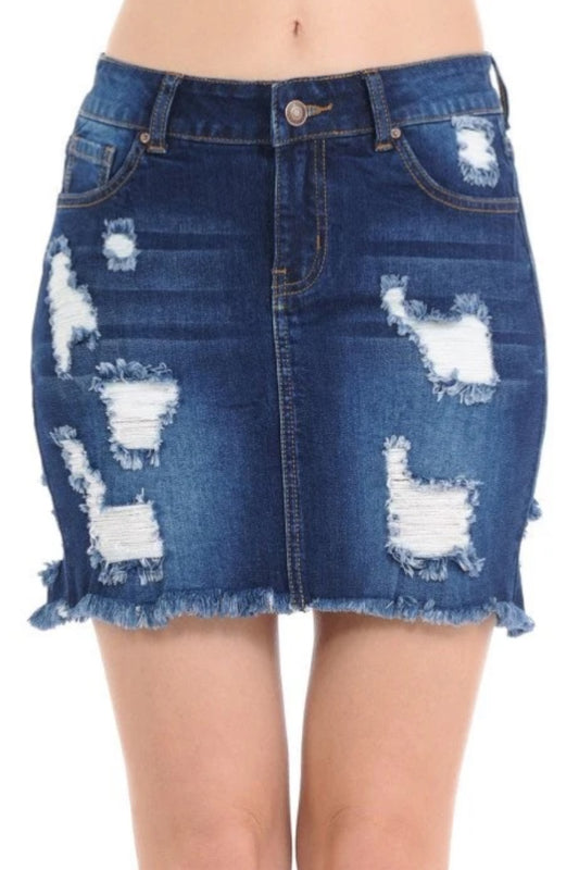 A blue denim mini skirt with distressed rips and frayed hems, shown on a model against a white background.