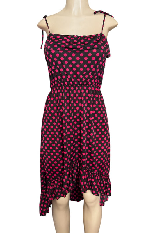 hot pink and black polka dot dress on a mannequin against a white background
