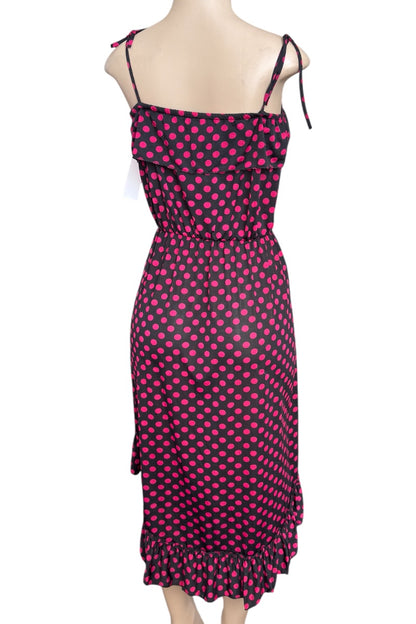 Black and pink polka dot dress on a mannequin against a white background