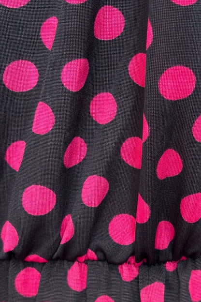 Close-up of black fabric with pink polka dots