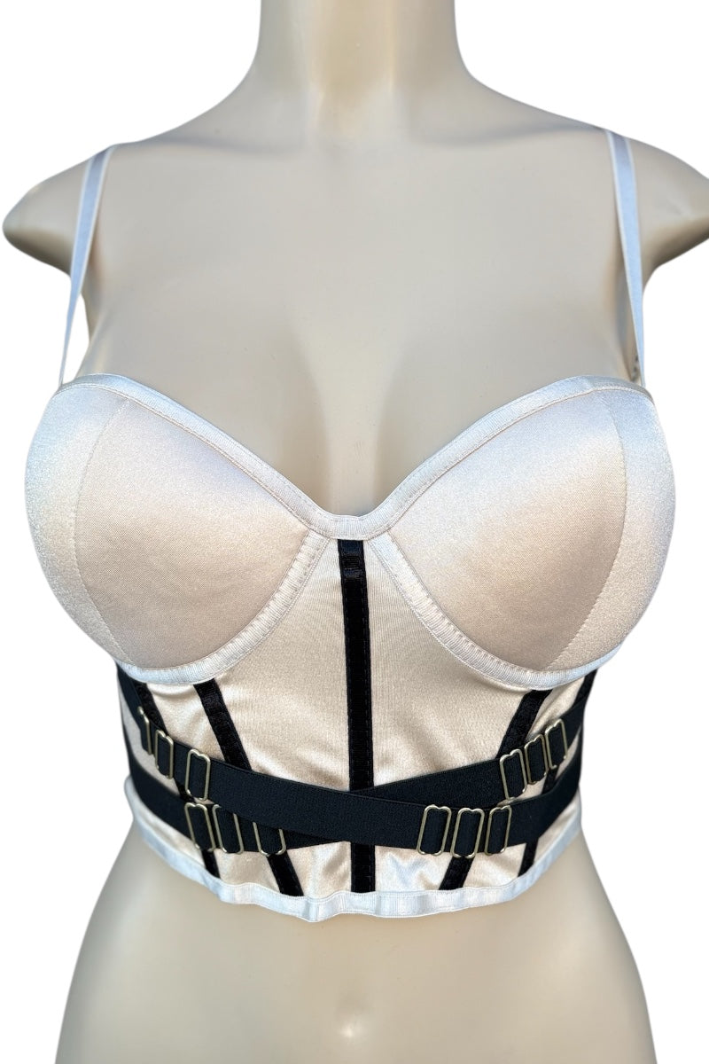 beige crop top with black straps on a mannequin against a white background