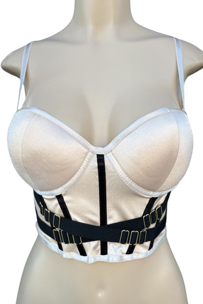 beige crop top with black straps on a mannequin against a white background