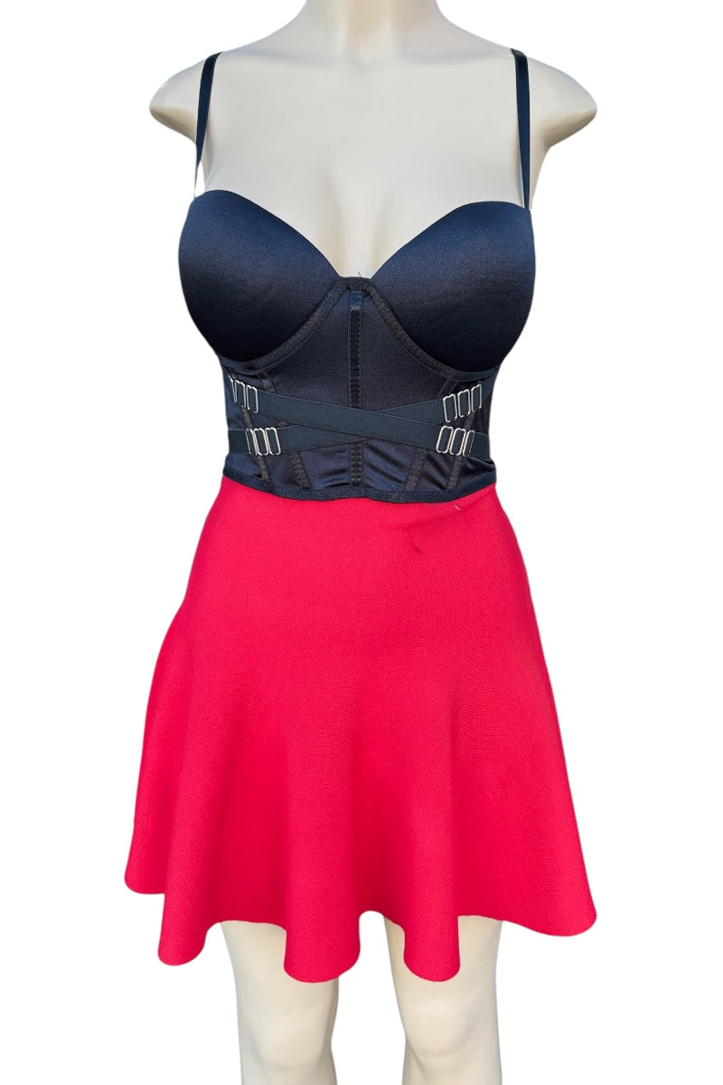 Mannequin wearing a black top and red skirt with a white background