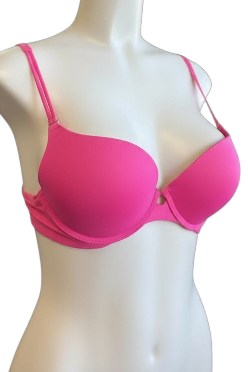 Pink bra on a mannequin against a white background