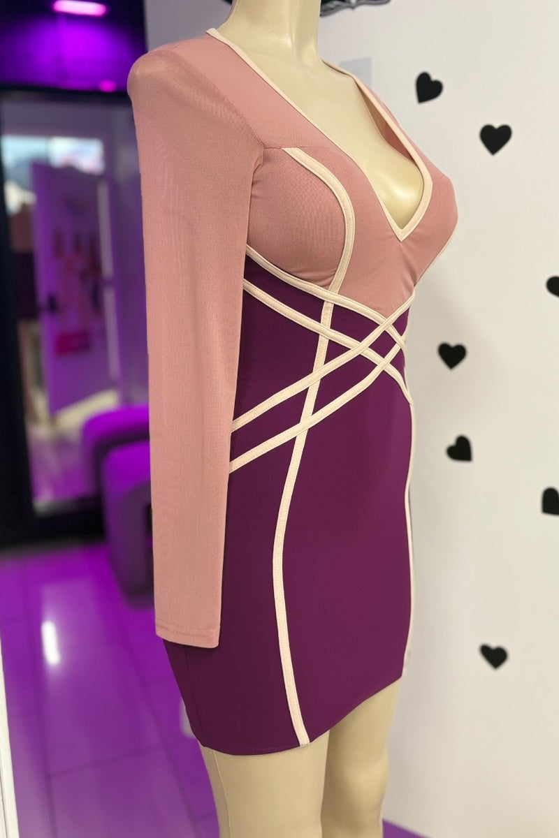 Mannequin wearing a two-tone dress with pink top and purple skirt against a white background with black hearts.