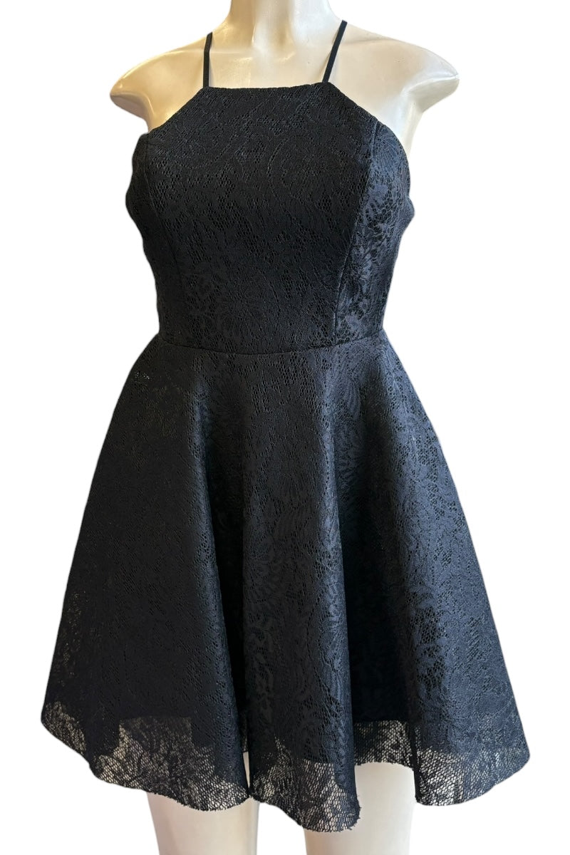 Black lace dress on a mannequin against a white background