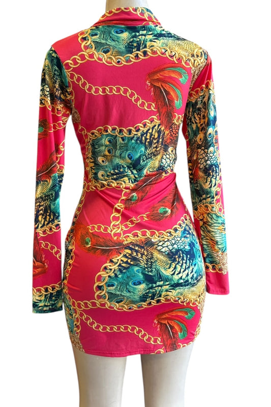 Colorful dress with peacock print and gold chain details on a white background