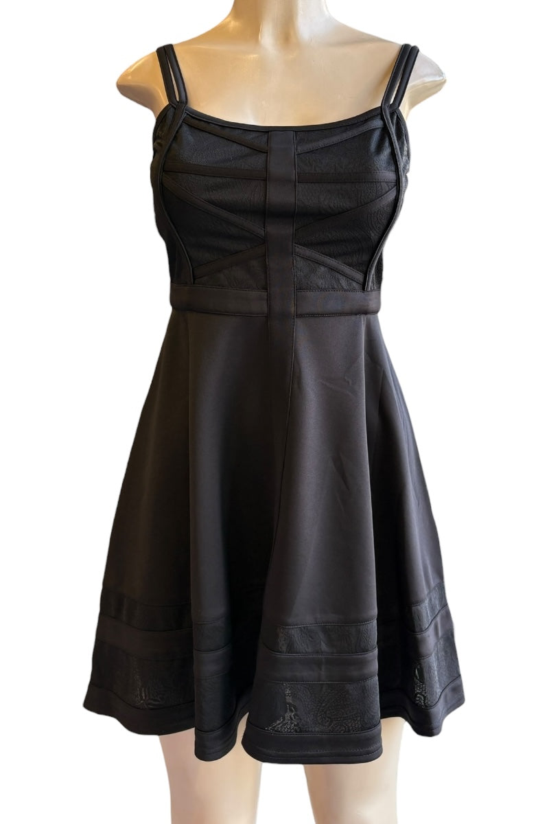 Black dress on a mannequin against a white background