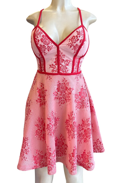 red floral dress on a mannequin against a white background