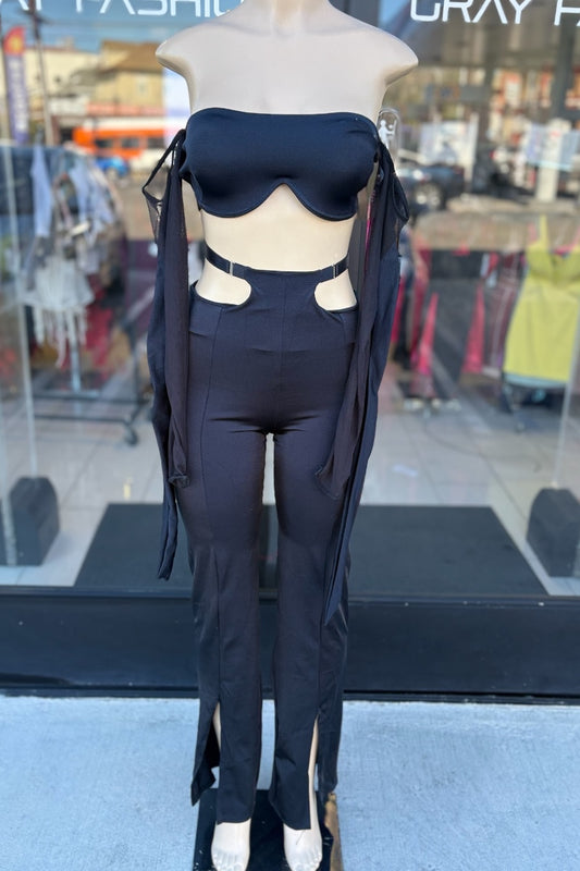 Mannequin wearing a black outfit with a blurred store interior background