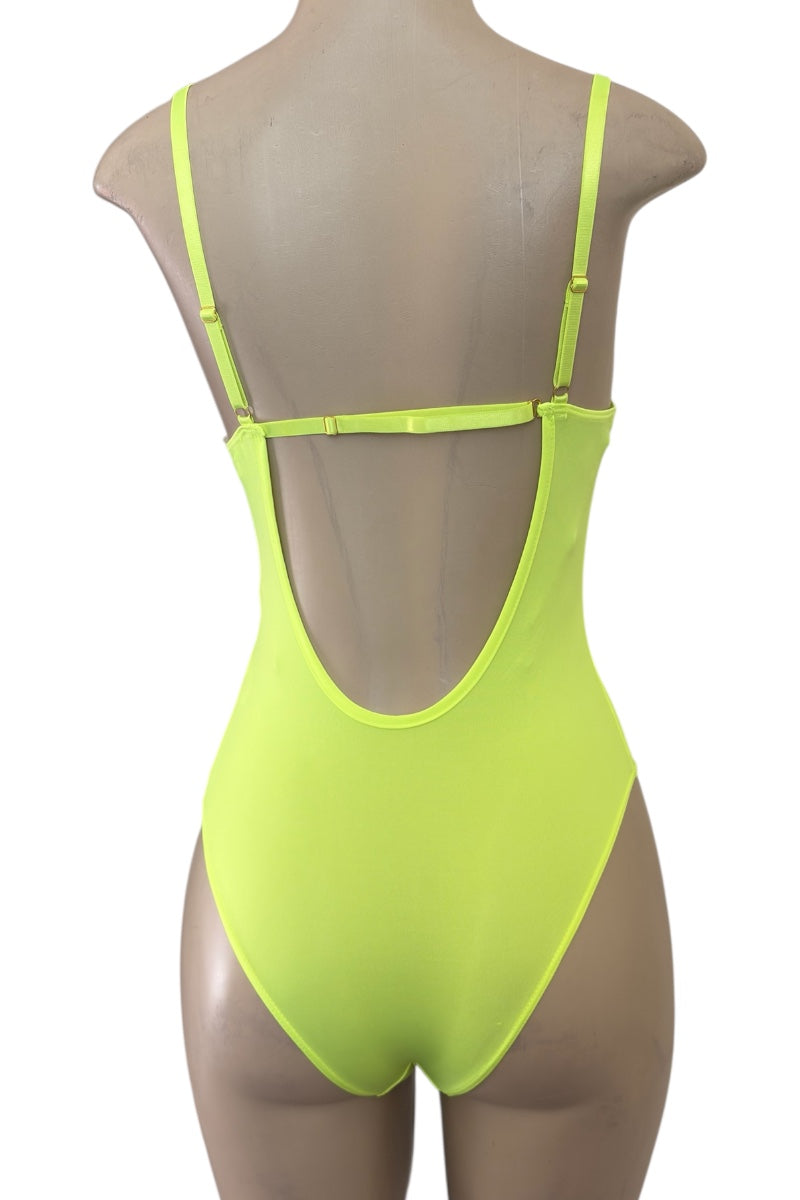 Neon yellow bodysuit on a mannequin against a white background