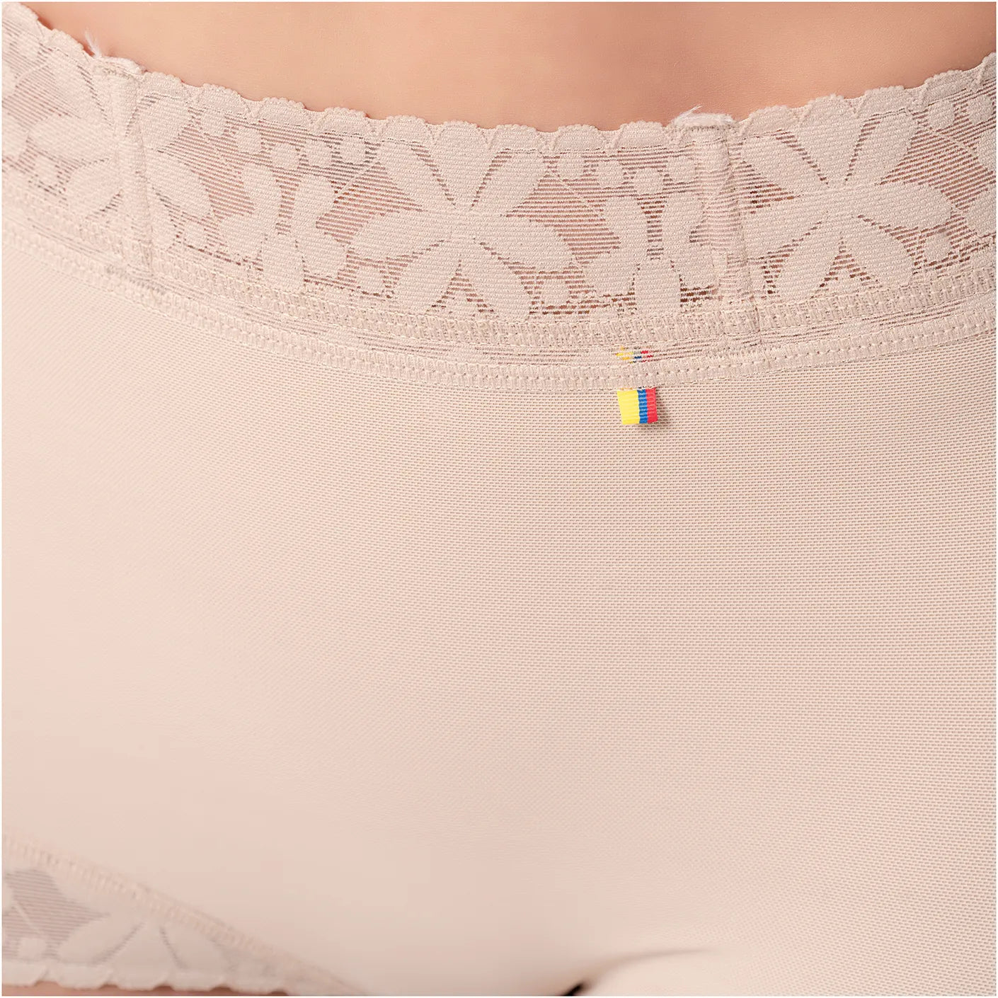 Close-up of beige lace-trimmed underwear with a brand logo.