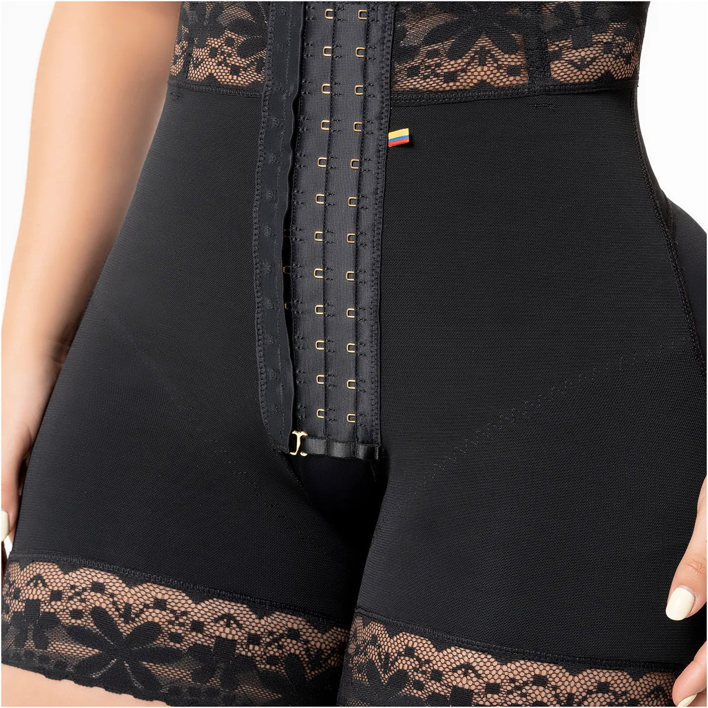 Black corset with lace details on a person wearing it.
