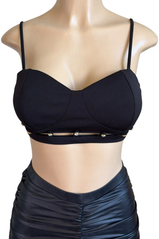 Black crop top with thin straps on a mannequin against a white background