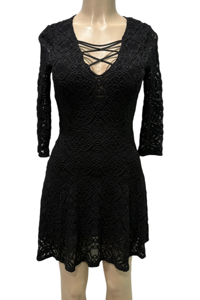 Black lace dress on a mannequin against a white background
