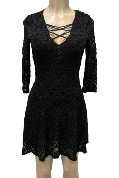 Black lace dress on a mannequin against a white background