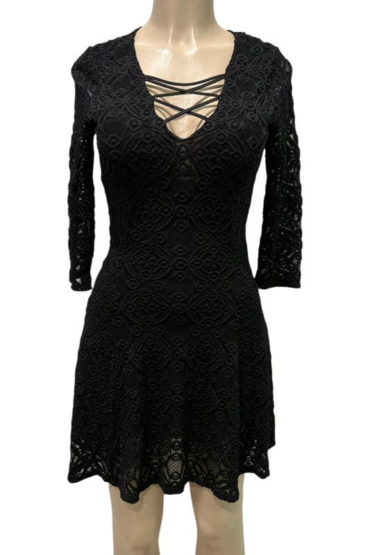 Black lace dress on a mannequin against a white background