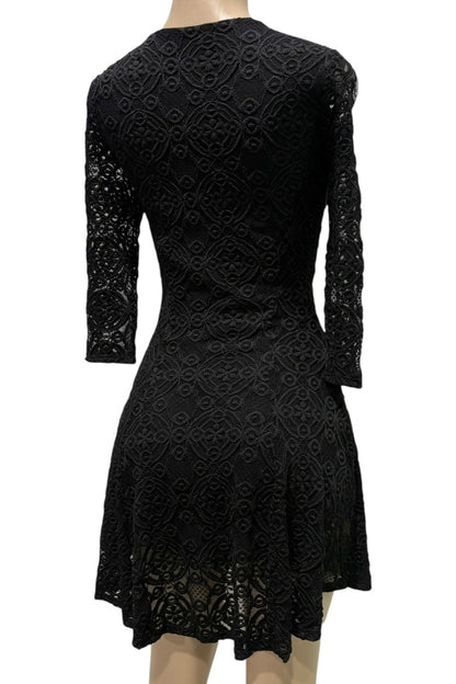 Black lace dress on a mannequin against a white background