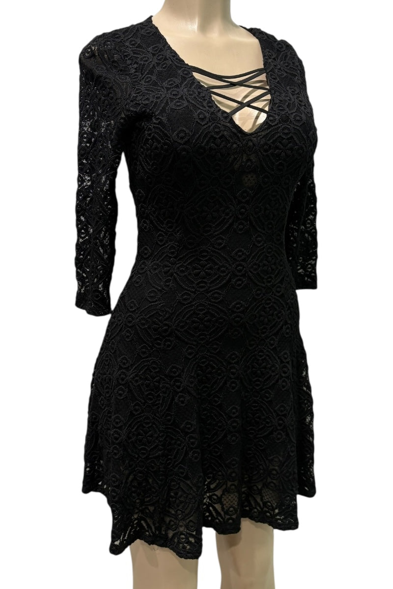 Black lace dress on a mannequin against a white background