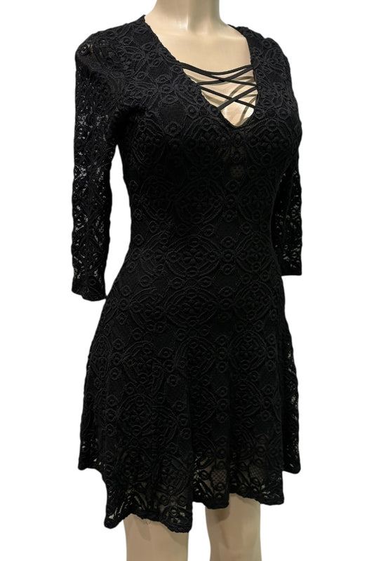 Black lace dress on a mannequin against a white background