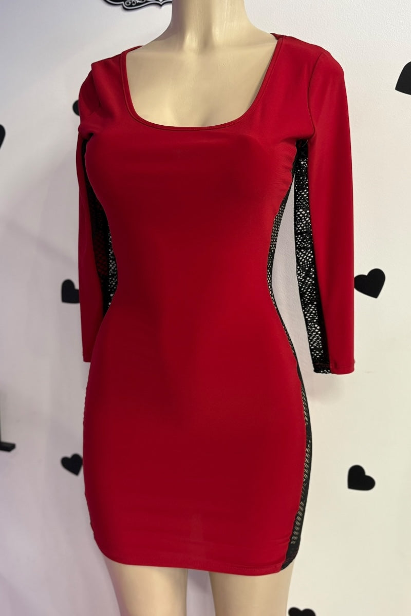 Red dress with black accents on a mannequin against a white background
