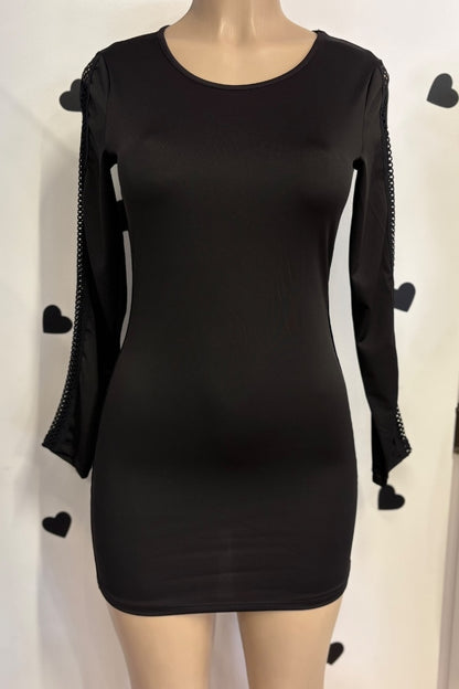 Black dress with unique sleeve designs on a mannequin against a white background