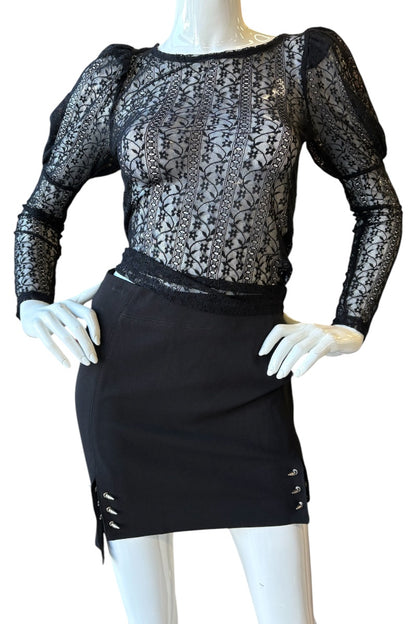 Mannequin wearing a black lace top and black skirt on a white background