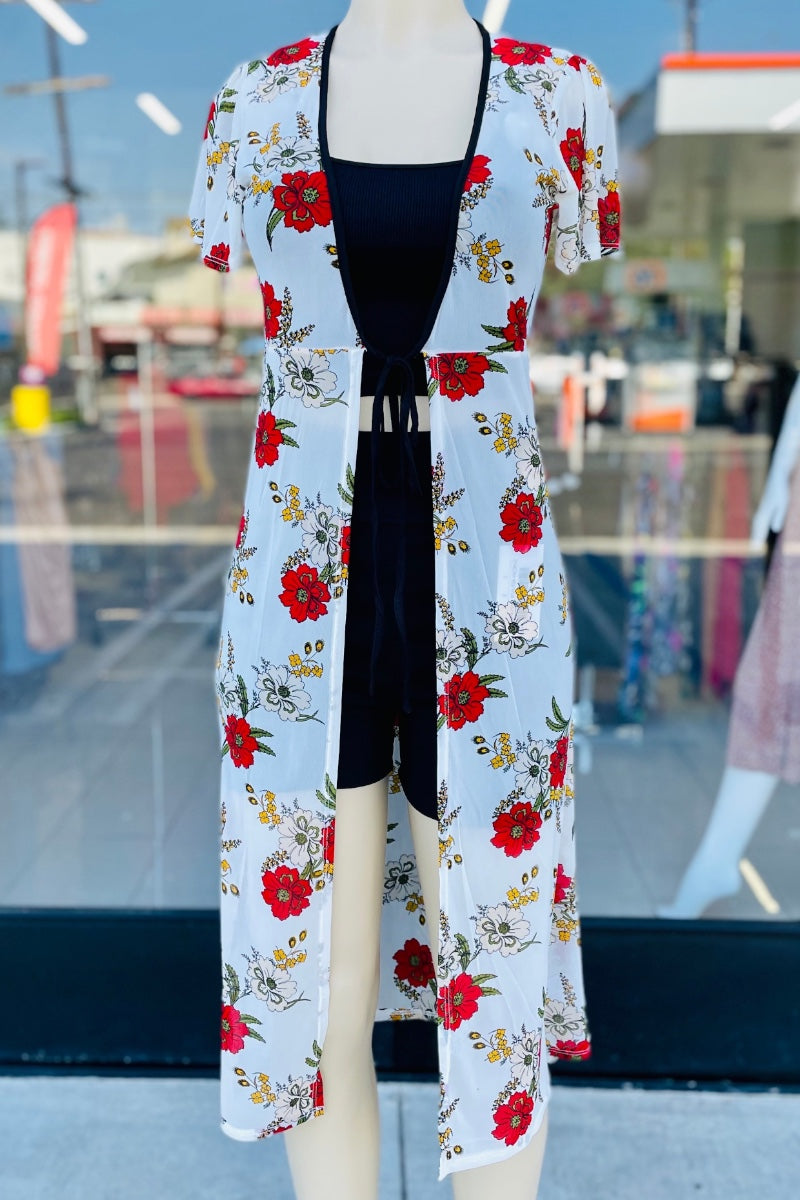 Mannequin wearing a floral kimono with a black top in an outdoor setting.