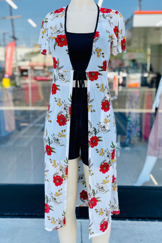 Mannequin wearing a floral kimono with a black top in an outdoor setting.