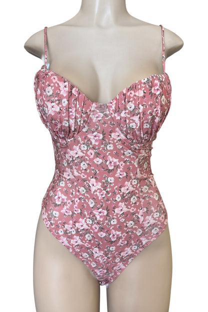 Pink floral bodysuit on a mannequin against a white background