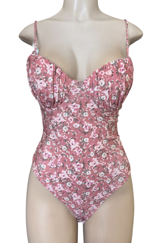 Pink floral bodysuit on a mannequin against a white background