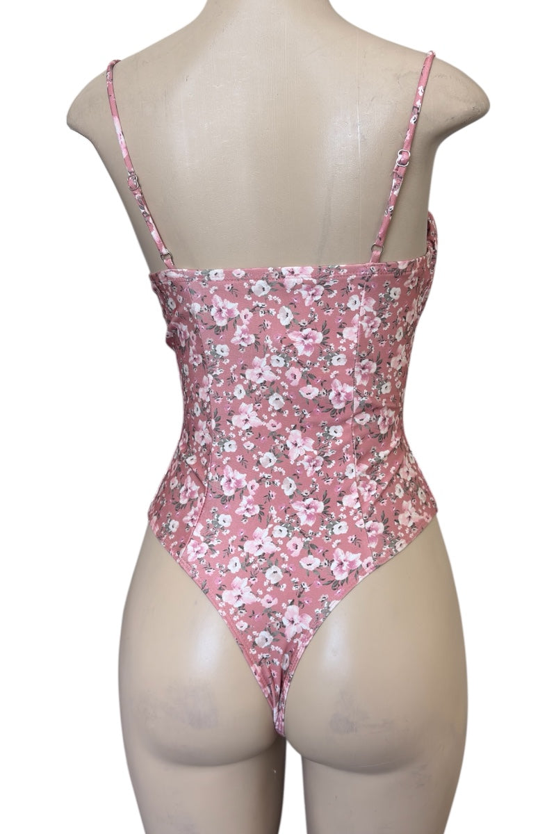 Pink floral bodysuit on a mannequin against a white background