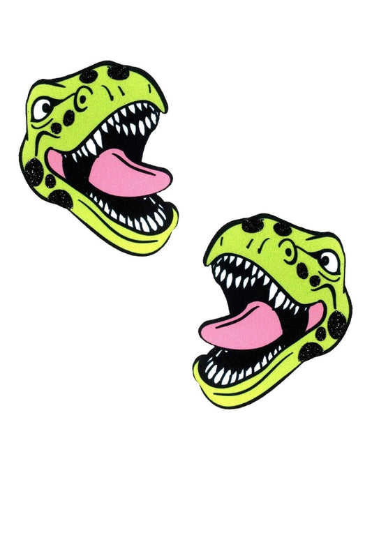 Two green dinosaur head pasties with open mouths on a white background
