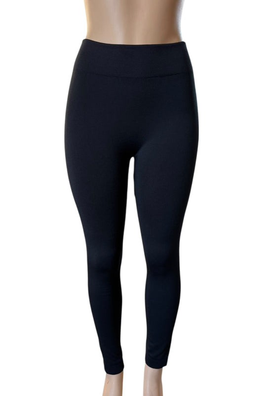 Black leggings on a mannequin against a white background