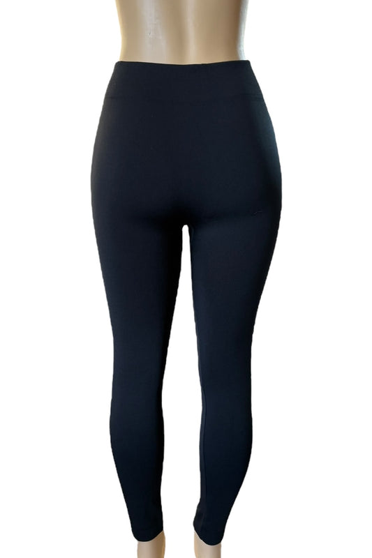 Black leggings on a mannequin against a white background