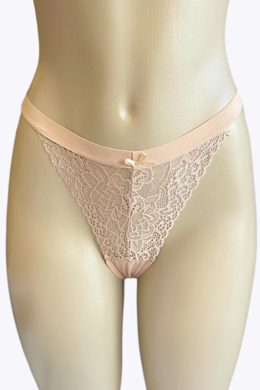 Beige lace thong on a mannequin against a white background