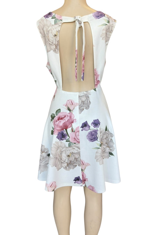 Floral dress with an open back on a mannequin against a white background