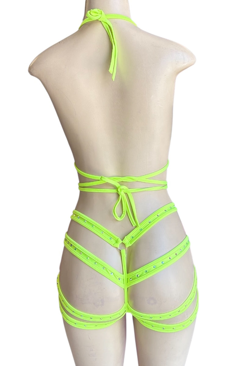 Neon yellow strappy outfit on a mannequin against a white background