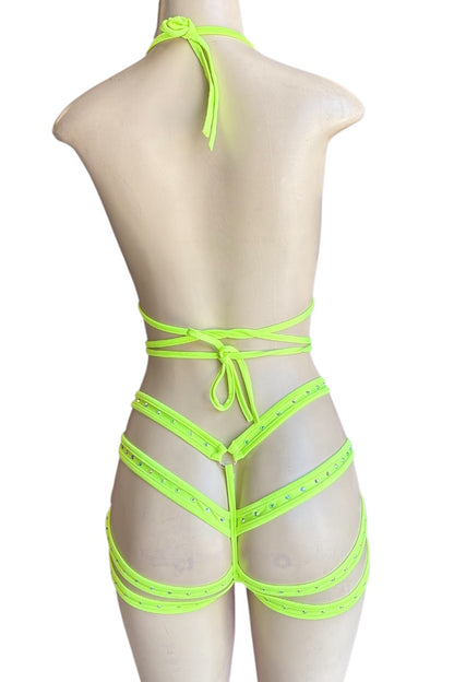 Neon yellow strappy outfit on a mannequin against a white background
