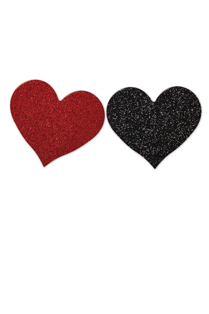 Two glittery heart-shaped pasties, one red and one black, on a white background.