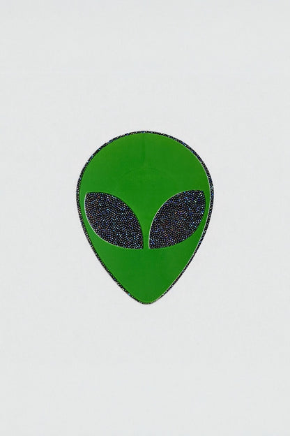 Green alien head pastie on a white background