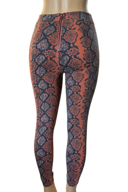Snakeskin pattern pants on a mannequin against a white background