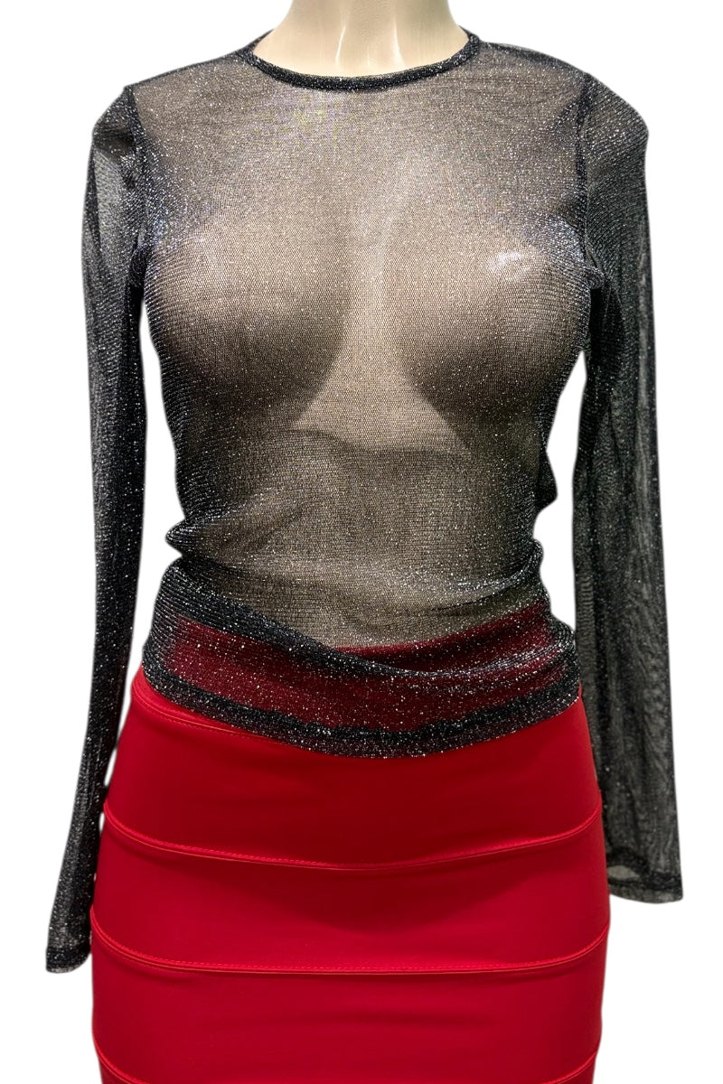 Mannequin wearing a sheer black top with long sleeves and a red skirt.