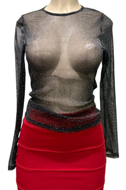 Mannequin wearing a sheer black top with long sleeves and a red skirt.