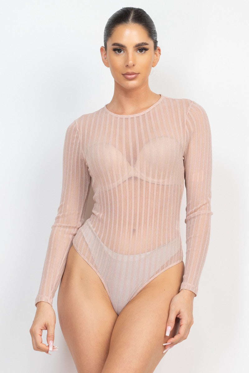 Model wearing a sheer ribbed long-sleeve bodysuit on a white background