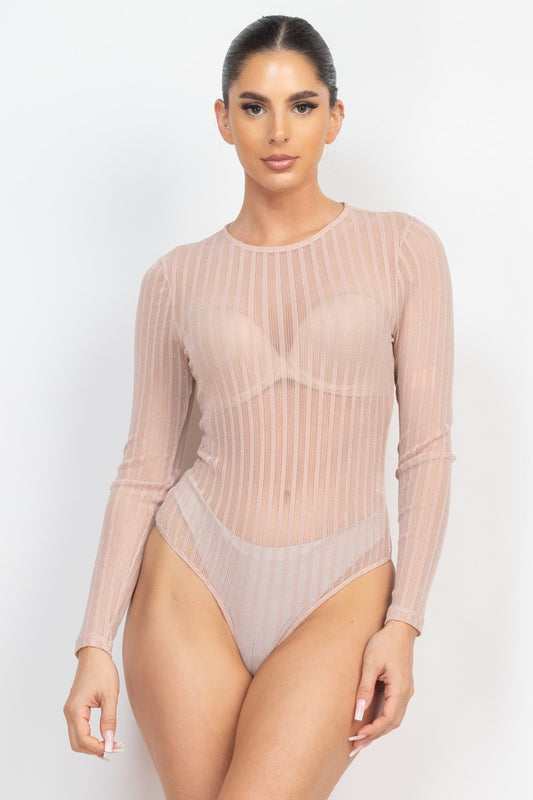 Model wearing a sheer ribbed long-sleeve bodysuit on a white background
