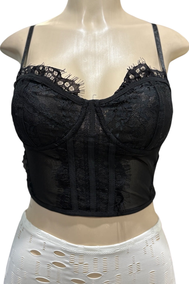Black lace corset top on a mannequin with a white lace skirt.