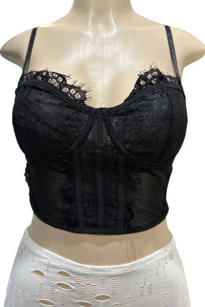 Black lace corset top on a mannequin with a white lace skirt.