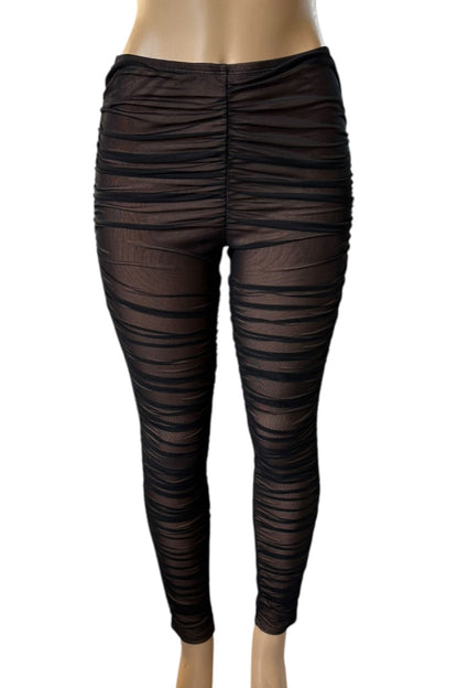 Black mesh leggings on a mannequin against a white background